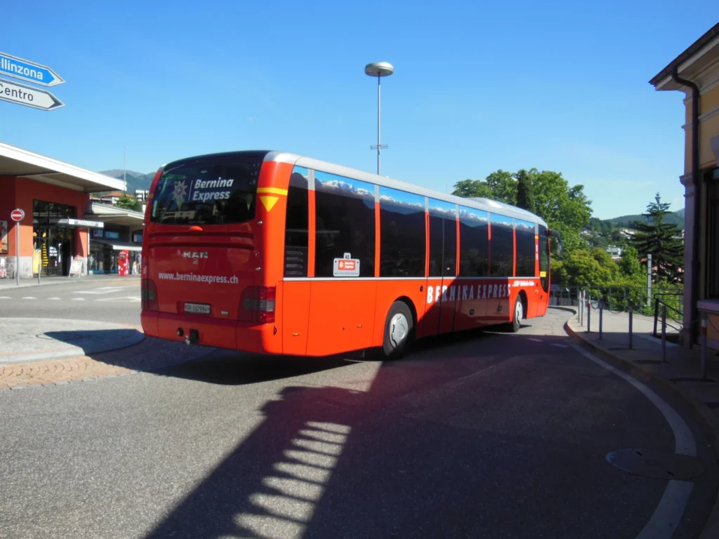 Red Bernina Express coach leaving Lugano railway station