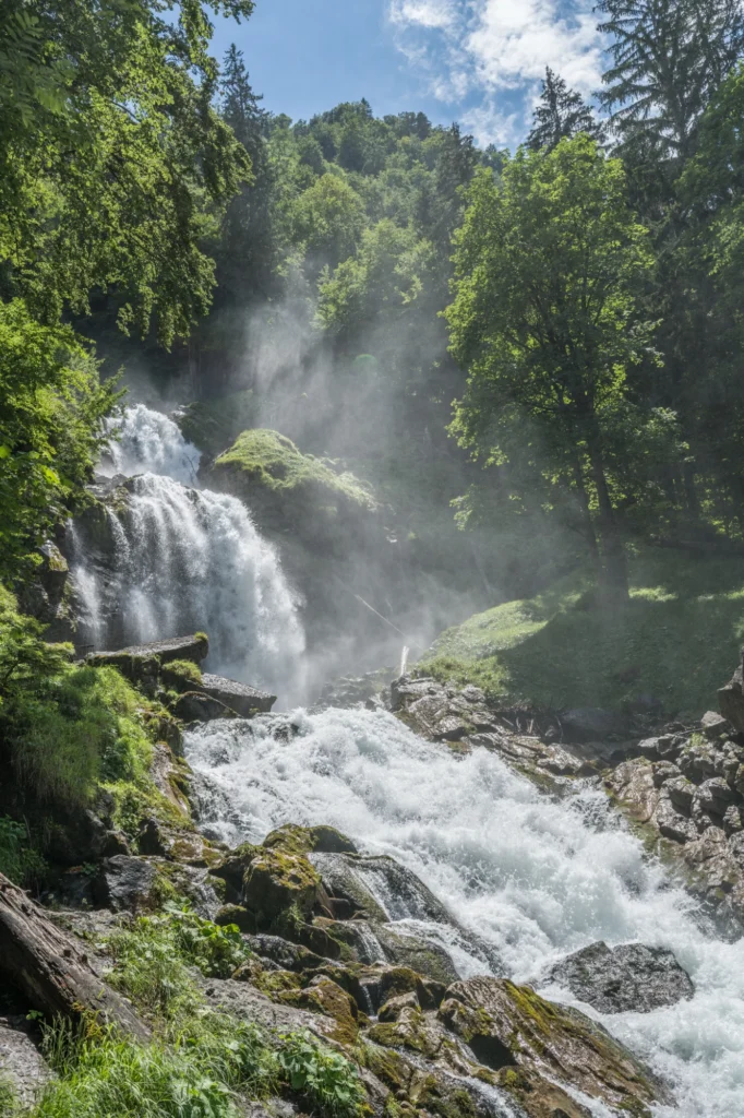 Obere Giessbachfälle stürzen über Felsen durch grünen Wald