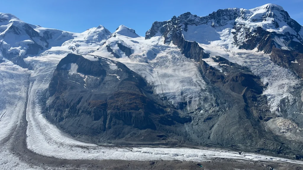 The Gorner Glacier flowing between snow-covered peaks of the Monte Rosa massif seen from the Gornergrat