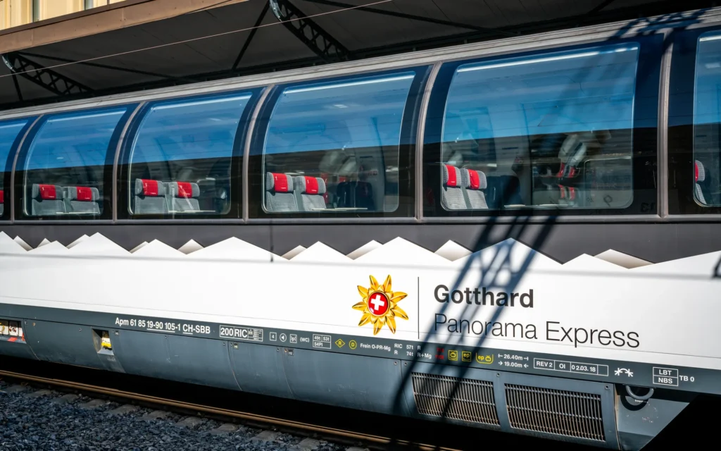 First-class panorama car of the Gotthard Panorama Express with its logo