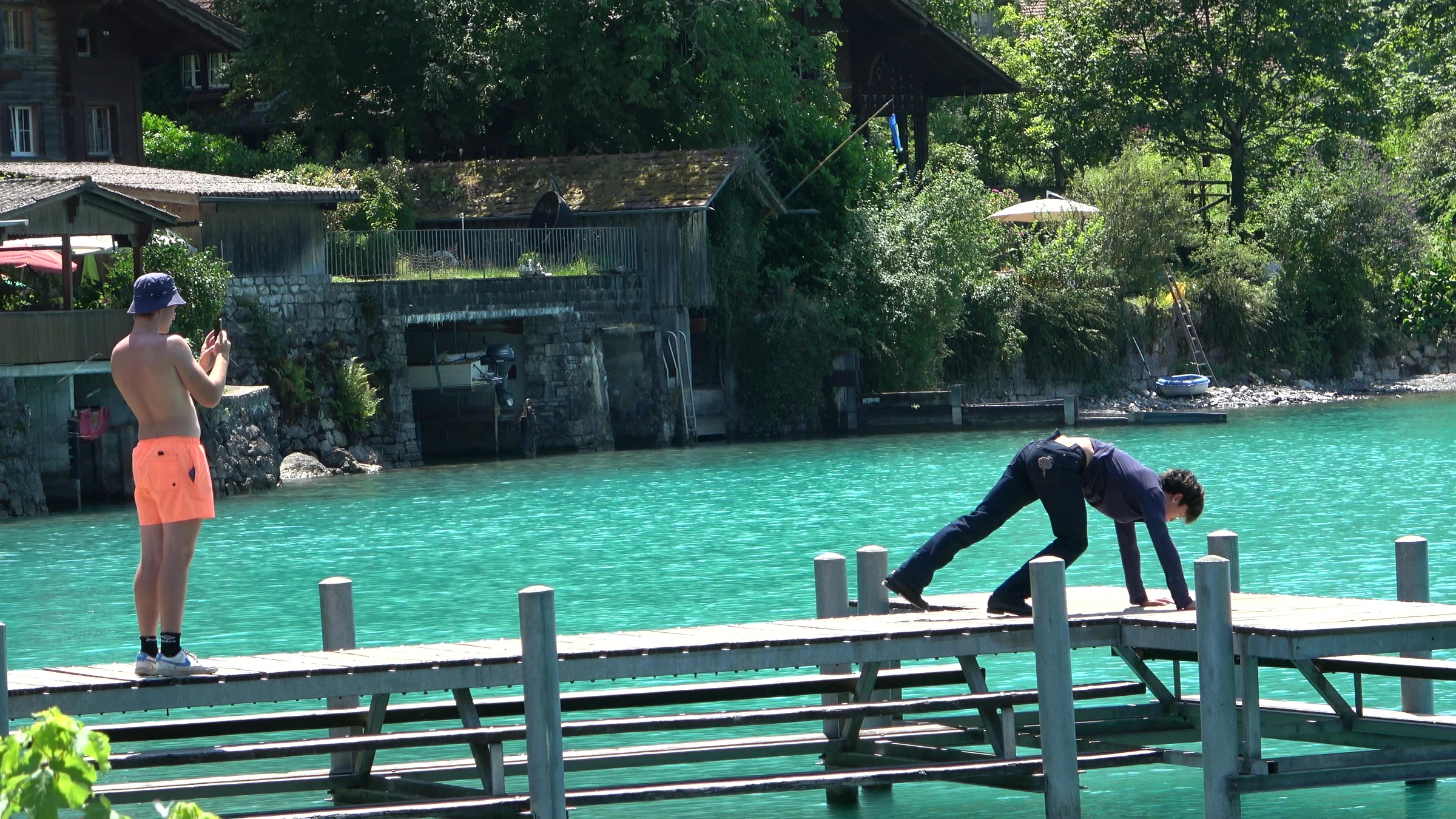 Influencer crawling across the planks of the Iseltwald pier for a funny clip