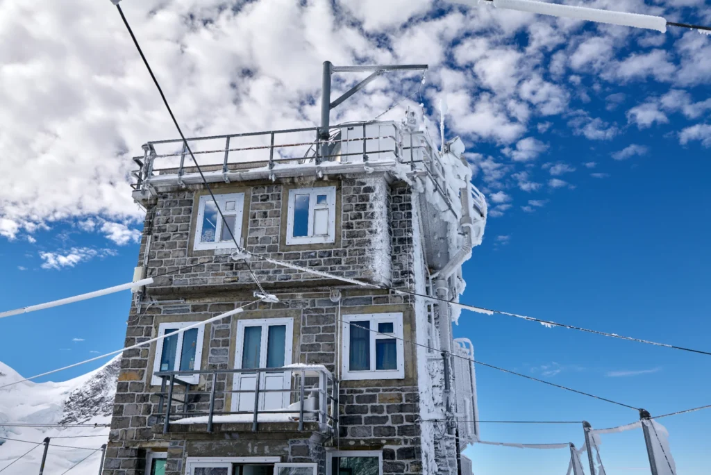 The Sphinx observatory building on the Jungfraujoch with its terrace railings under a blue sky