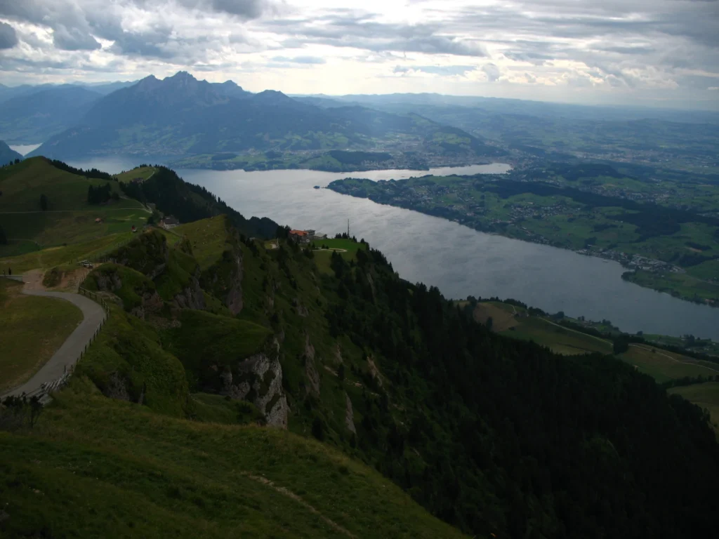 Lake Lucerne seen from Rigi Kulm with green slopes in front and Pilatus on the horizon