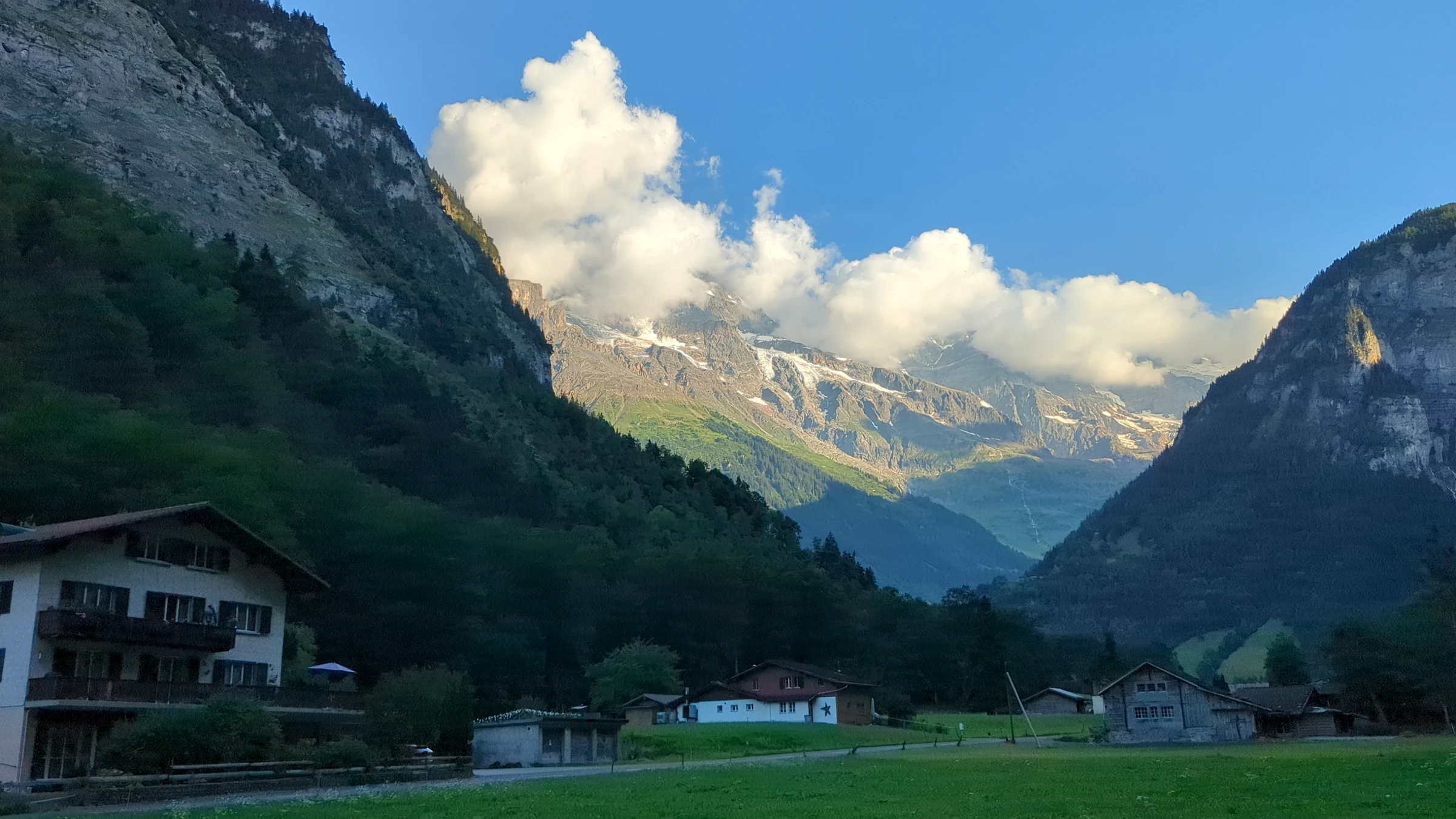 Evening view up the Lauterbrunnen Valley with clouds over the glaciers at its head