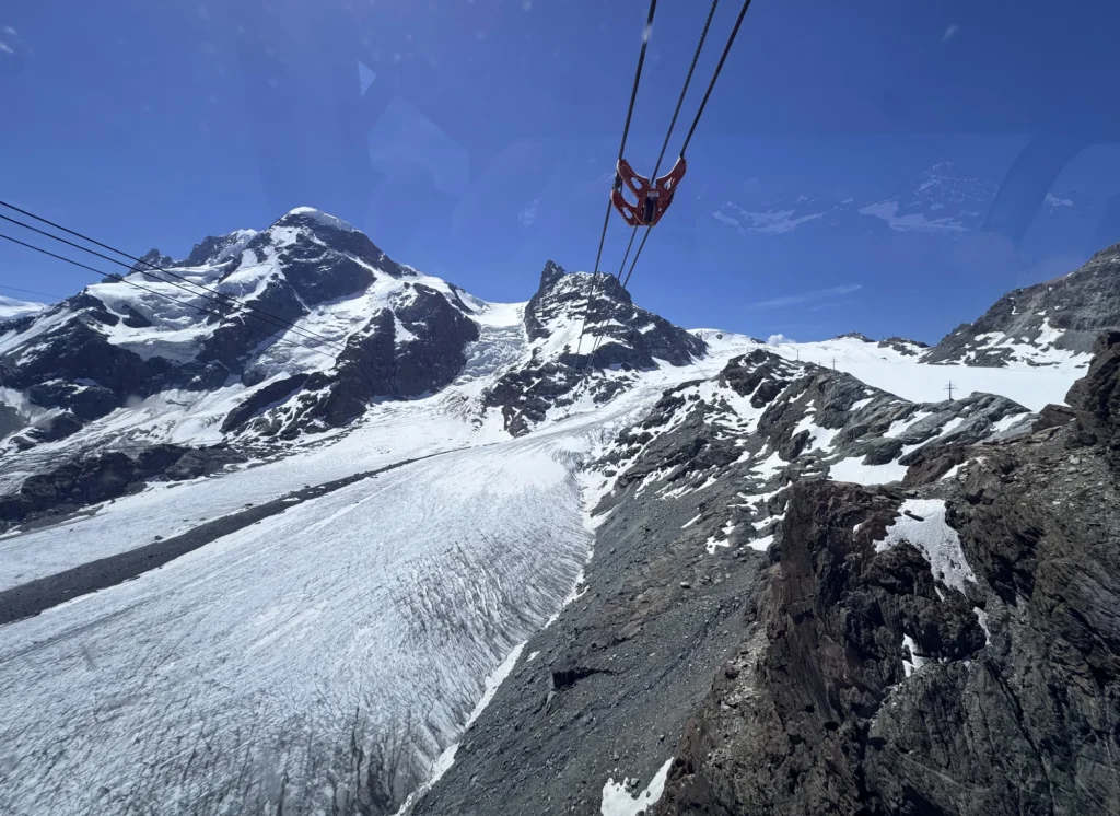 Cable car cables above a glacier and snowy peaks near Klein Matterhorn