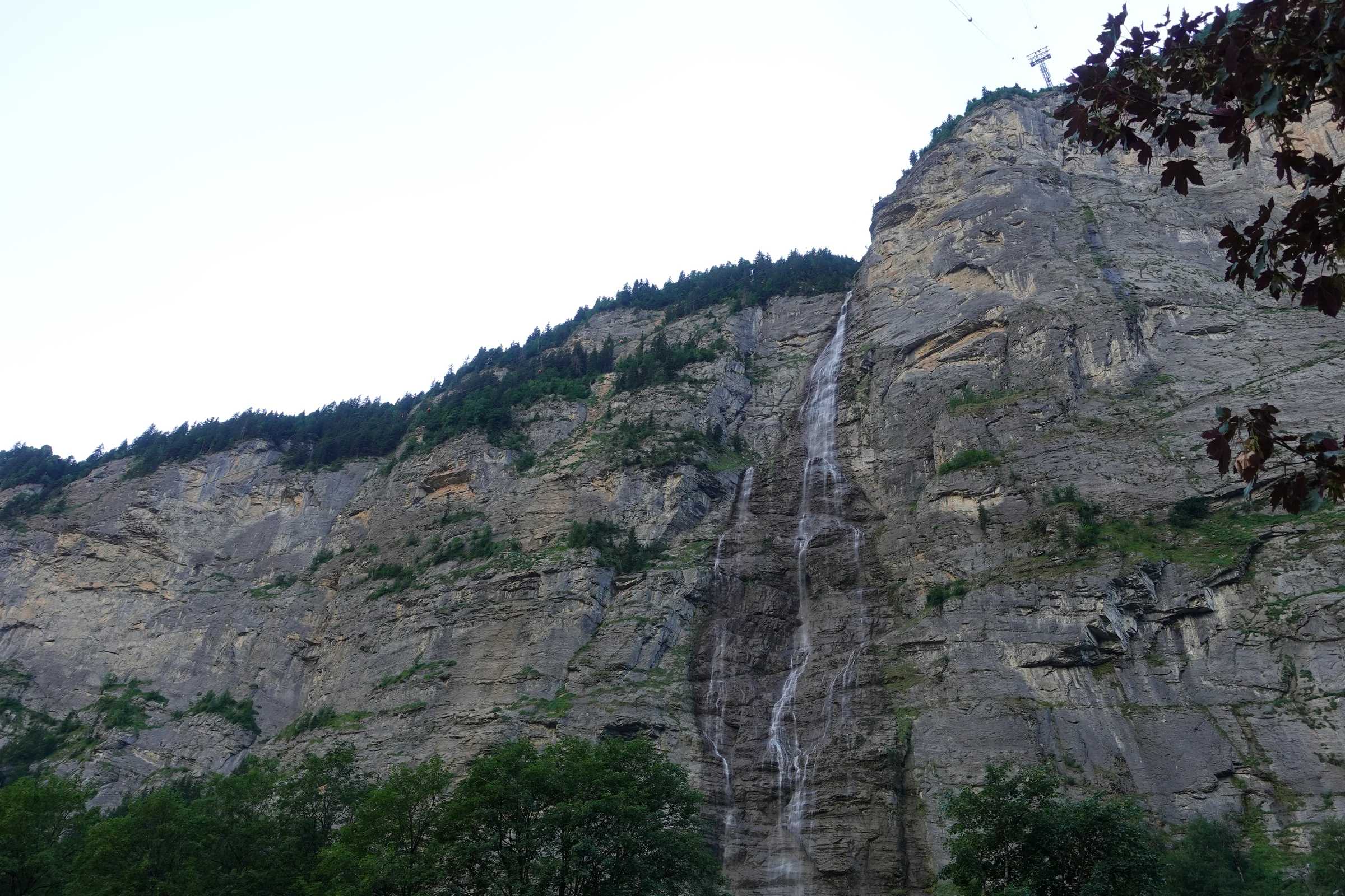 Mürrenbach Falls running down several steps of the cliff above Stechelberg in the evening